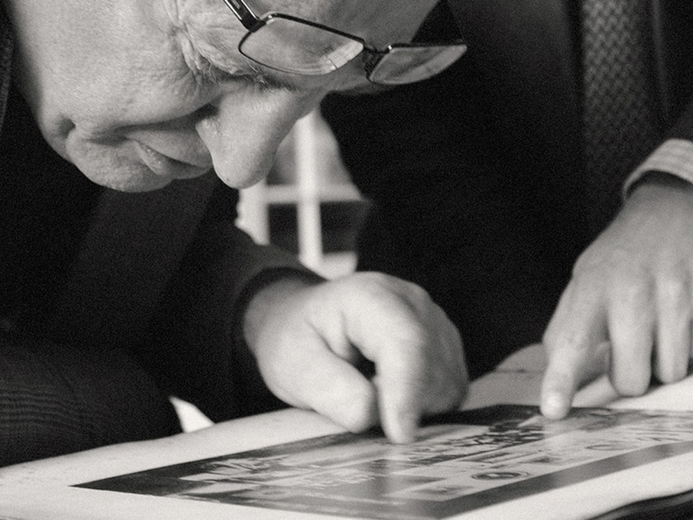 Adam's valuers examining a work on paper